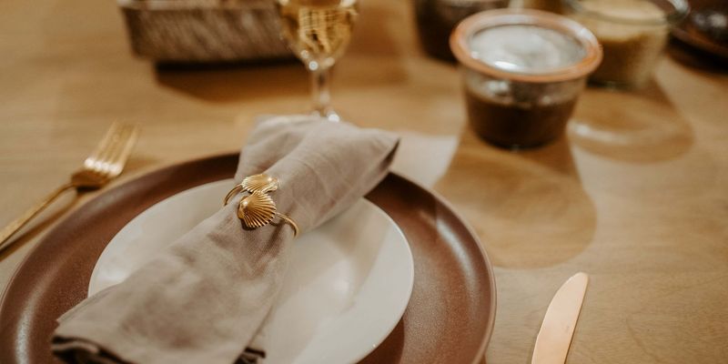 Plates with cutlery on the table of a lodge in Calviac